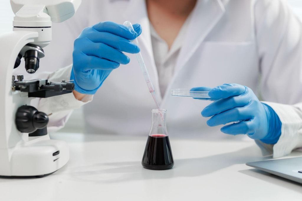 Pipette and microscope in a chemical laboratory